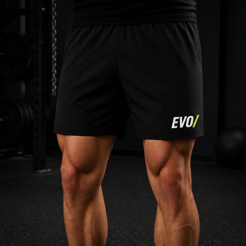 Athlete wearing black EVO training shorts in a dark gym